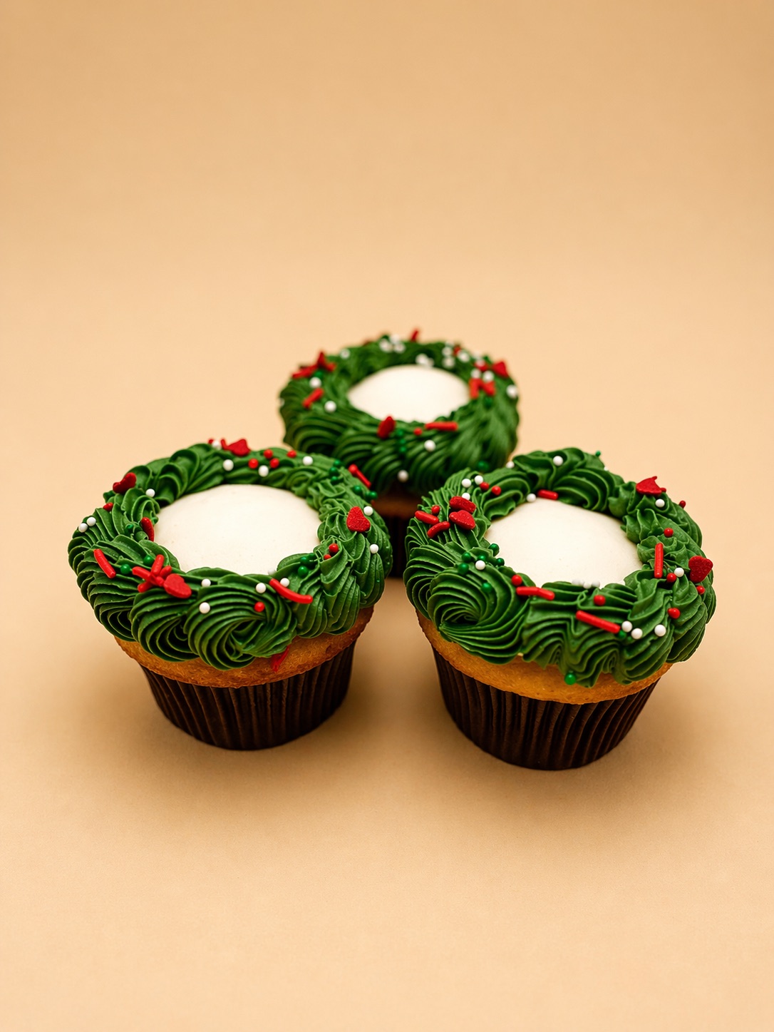 Christmas wreath cupcakes with green buttercream and festive sprinkles