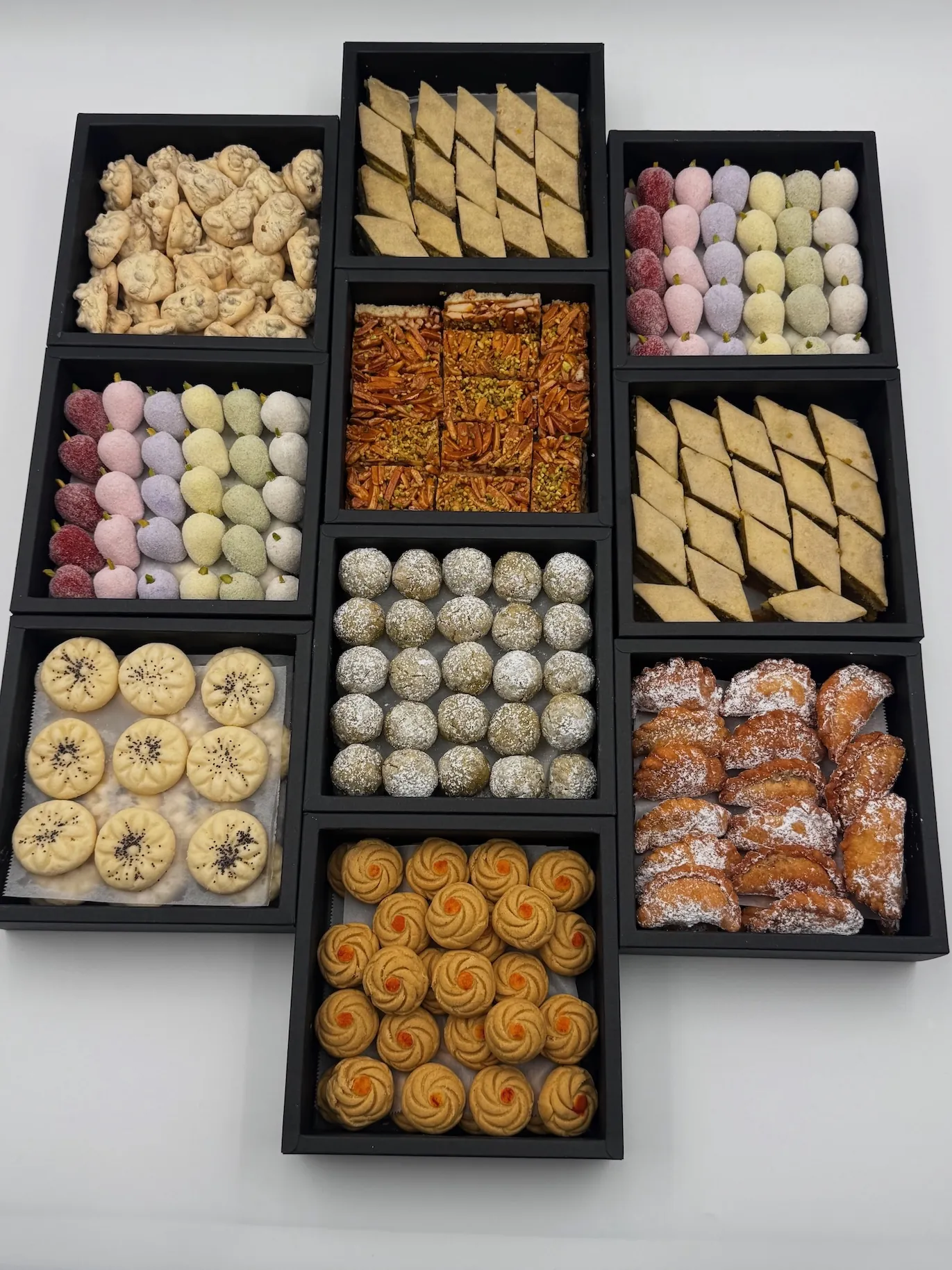 Assorted Persian and French pastries arranged in catering trays