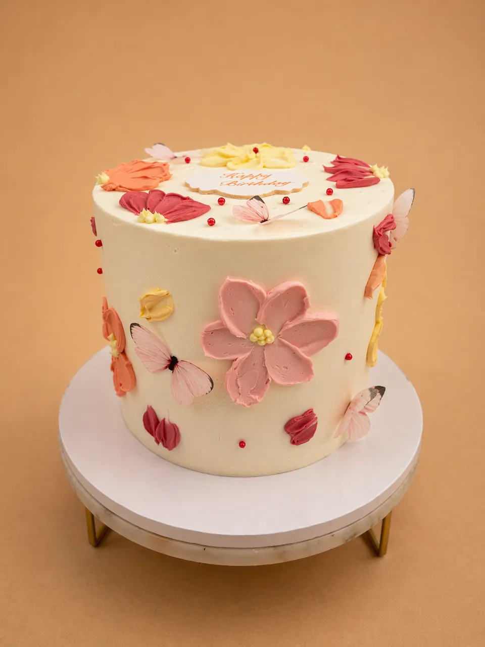 Butterfly floral birthday cake with soft colors
