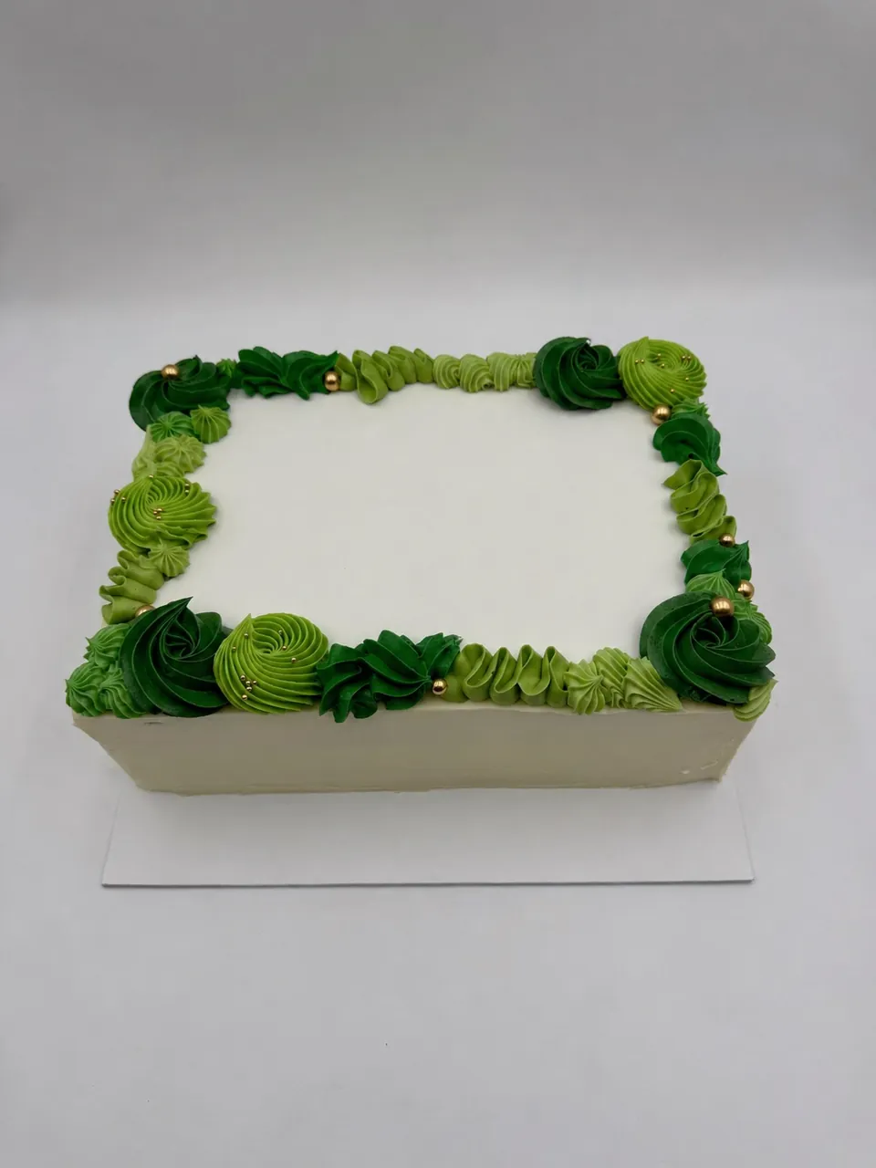 Green buttercream sheet cake with custom company logo