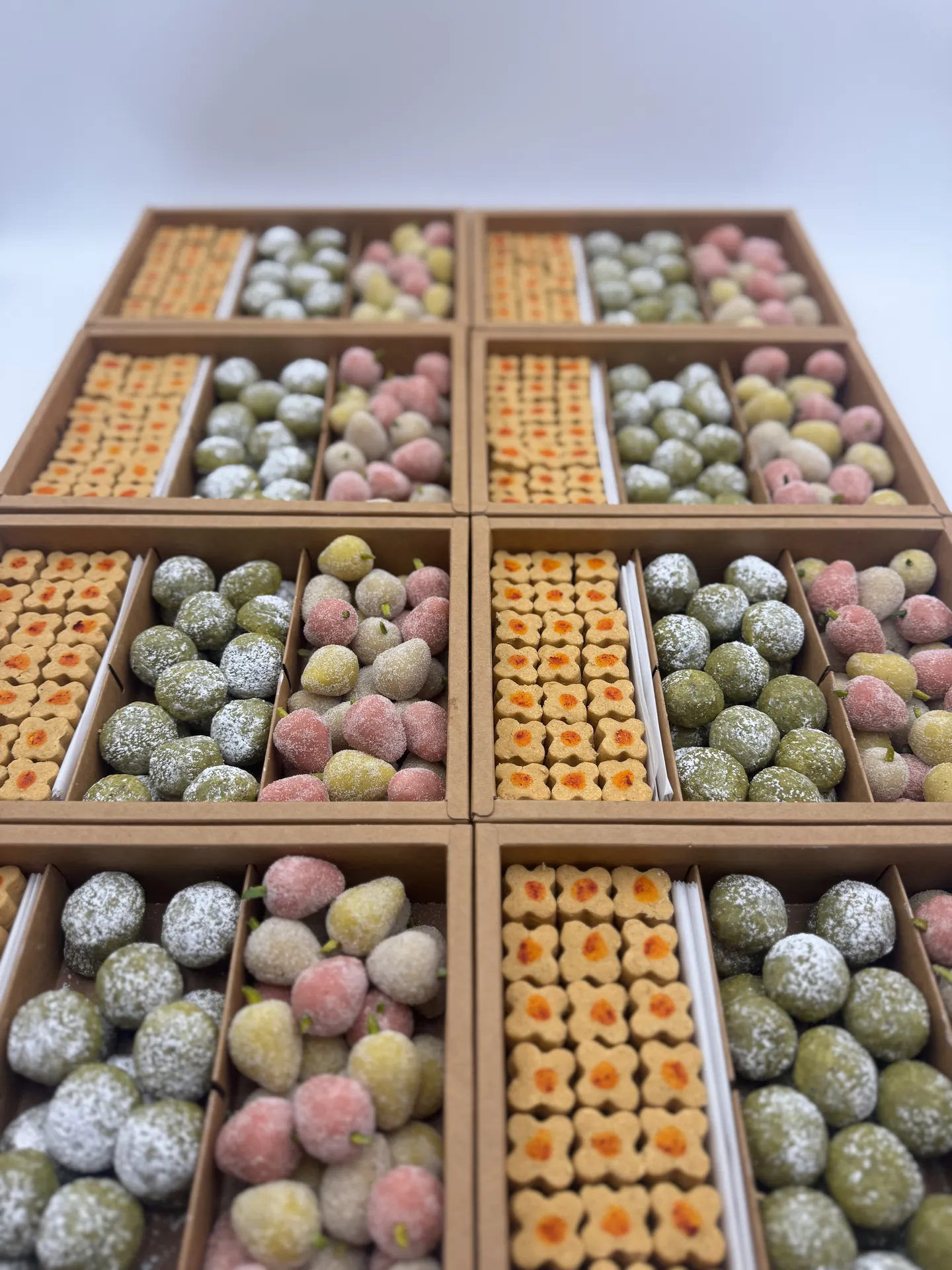 Wide view of several custom Persian pastry boxes