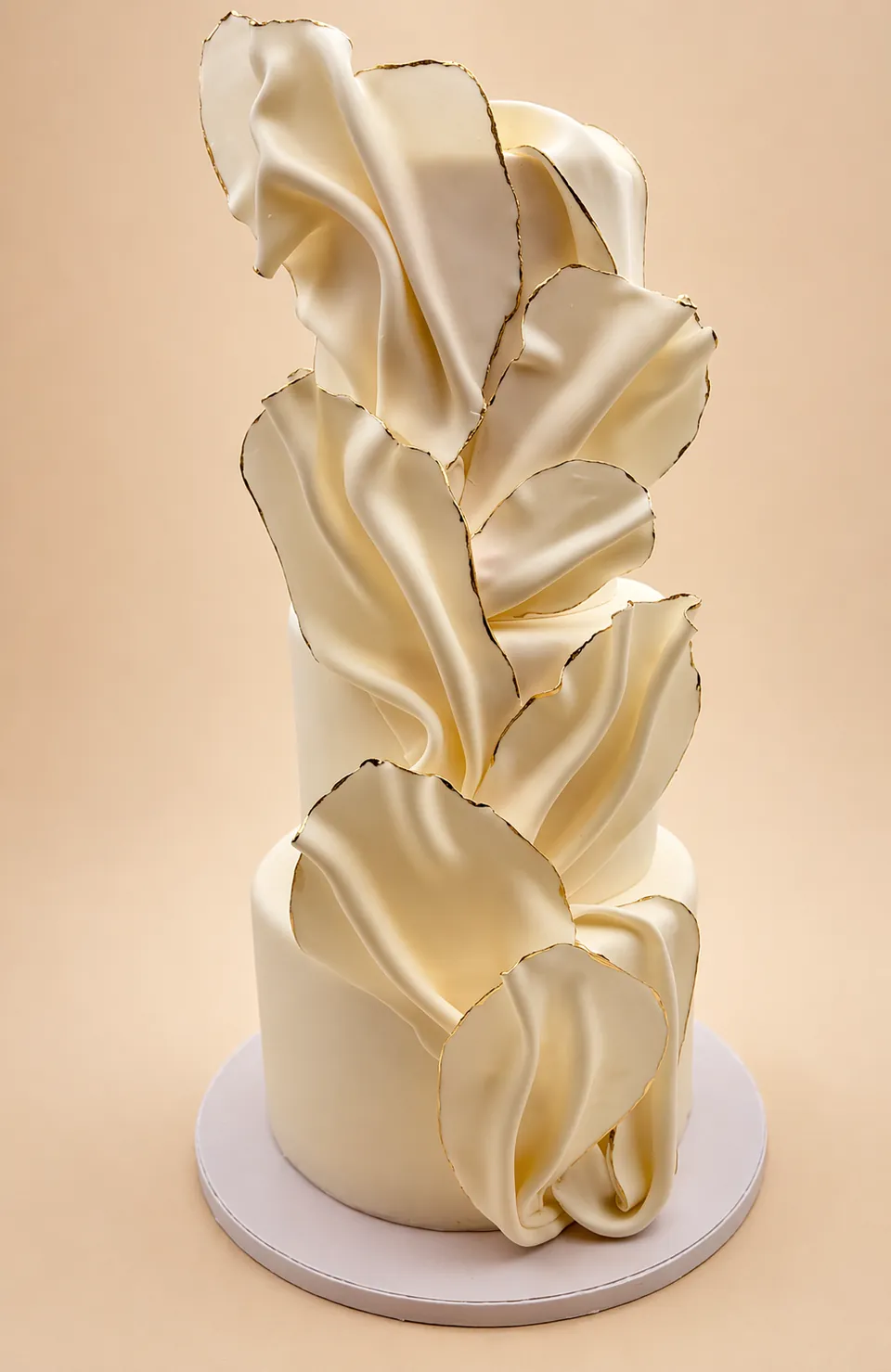 Three-tier semi-naked wedding cake with berries
