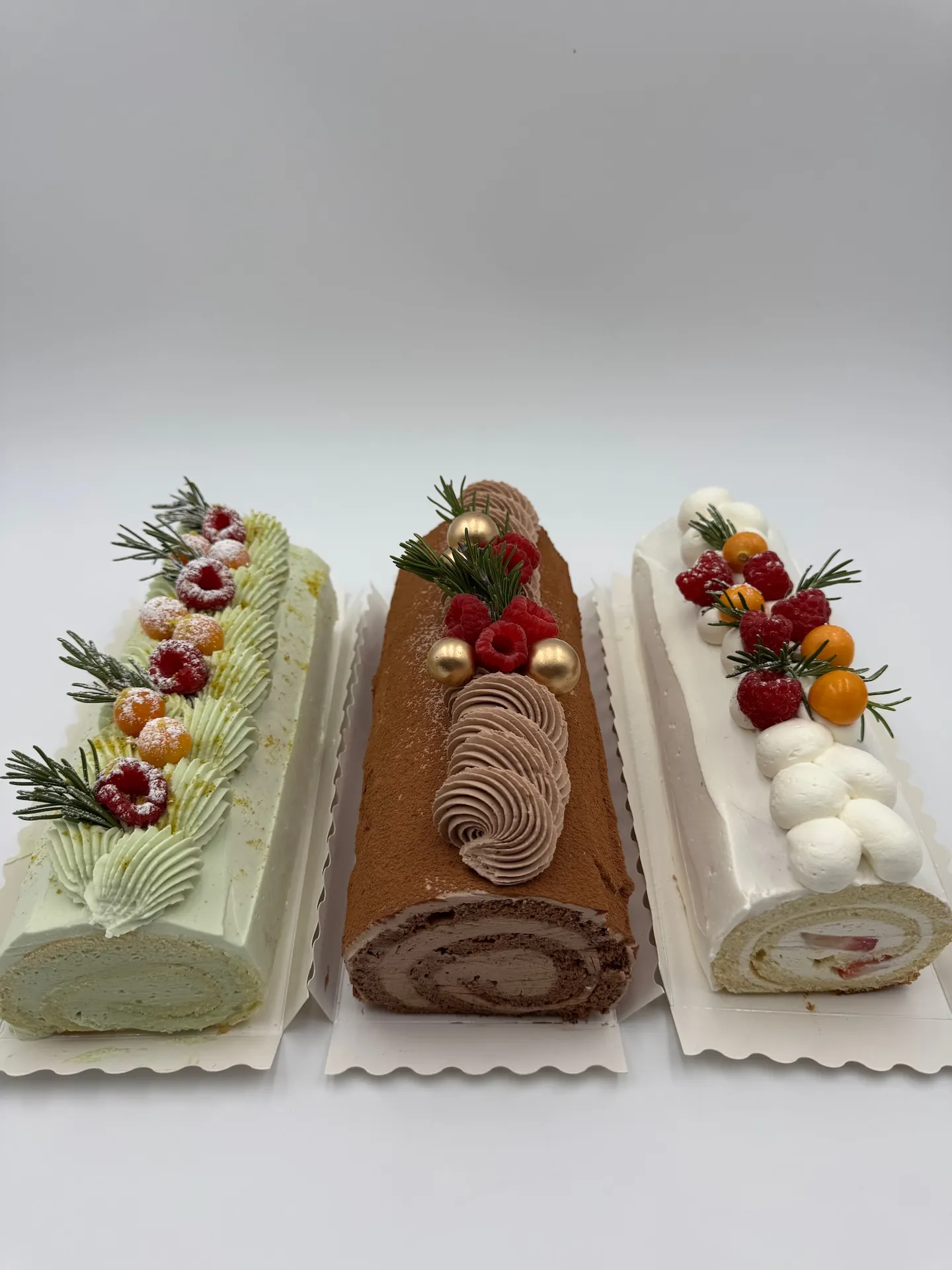 Pistachio, chocolate, and vanilla Swiss rolls decorated for dessert catering